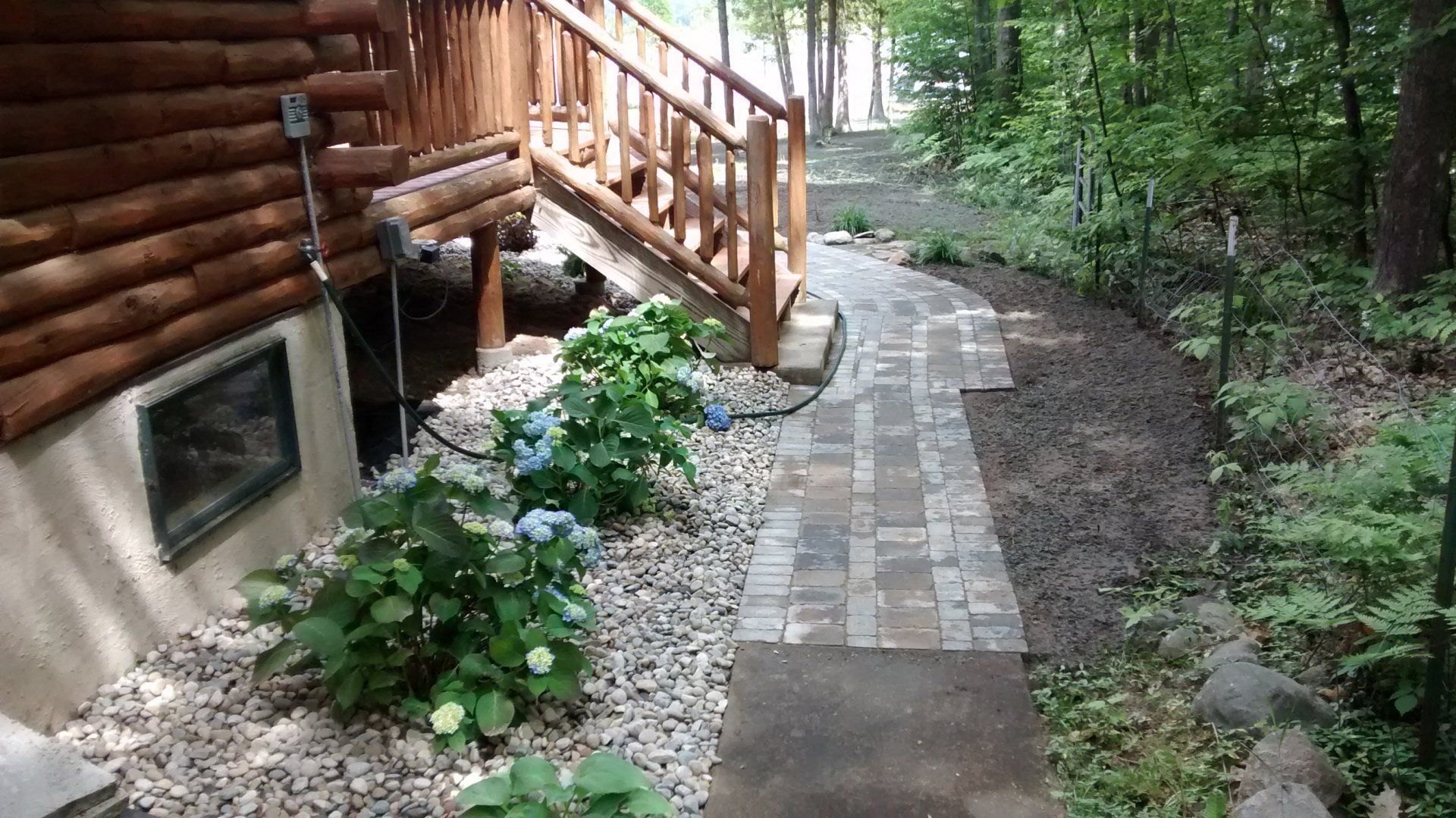 Boulder or stone retaining wall in a yard